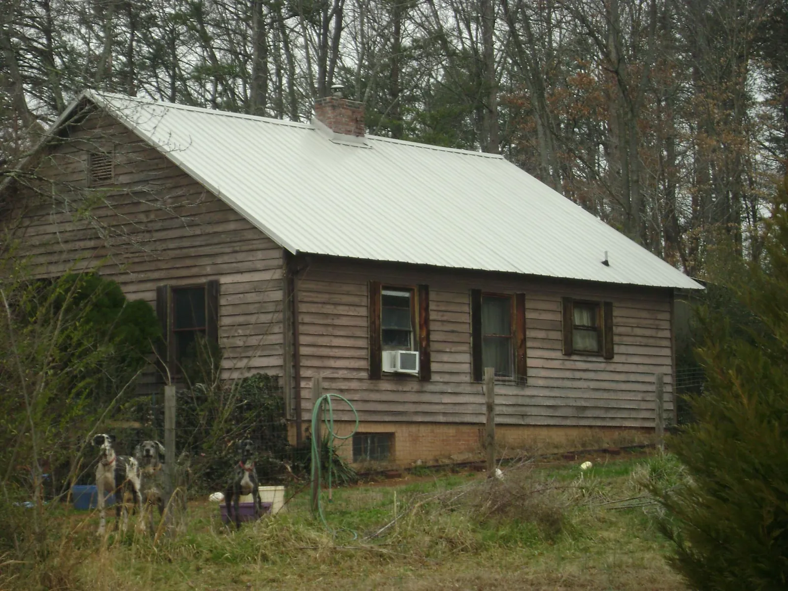 White metal roof on an old wood sided farmhouse, from a Metal Roof Installation job in East Lynn